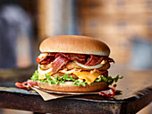 Chicken burger with bacon, cheese and onions