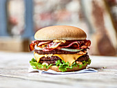 Burger of beef with bacon, cheese and onion