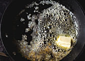 Butter heating in a frying-pan