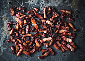 Grilled bacon cubes on an oven tray