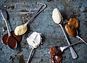 Various cream desserts on spoons