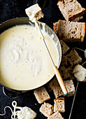 Cheese fondue with bread pieces
