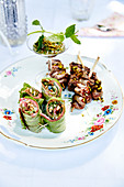 Roast beef rolls with mint pesto and pine nuts and lamb kebabs