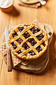 Small plum cake with pastry lattice