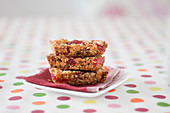 Muesli bars with strawberries on a dotted tablecloth
