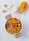 Ingredients for fusilli with pumpkin, chanterelles and crème fraîche