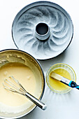 Prepare the chocolate cake: Grease the cake tin and sprinkle with flour