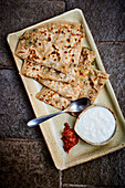 Naan bread with spinach filling and vegan coconut cream sauce
