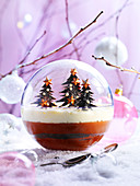 Enchanted forest dessert with two kinds of chocolate served in a snow globe