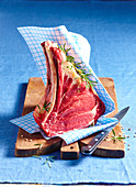 Raw beef chops on a wooden board
