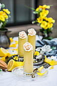 Coconut-lemon mousse in tall glasses decorated with rose petals