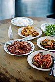 Beef rendang with various side dishes