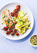Salmon steak with leek and potato puree and baked tomatoes