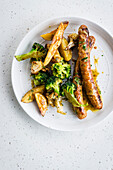 Poultry sausages with potato wedges and broccoli