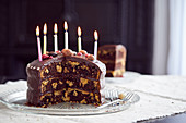 Three-layered vanilla and chocolate marble cake with candles for a Birthday