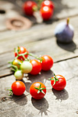 Fresh cherry tomatoes on an outdoor wooden table