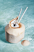 Coconut water in coconut with straws