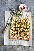 Goat's cheese and courgette flaky pastry tart with mint and pink pepper