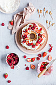 Ring-shaped birthday cake with cream and fresh berries