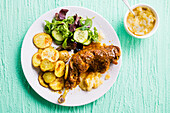 Roast chicken leg with roast potatoes and apple sauce