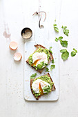 Bread slices with guacamole and poached eggs