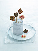 Marshmallows on skewers with puffed rice, chocolate and almonds