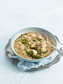 Broth with rice, bonito, cabbage sprouts and onions