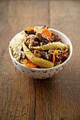 Fried noodles with lamb, carrots and baby corn