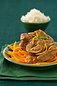 Osso bucco with saffron and oranges on carrot strips