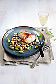 Monkfish wrapped in ham with beans