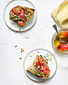 Pickled peppers with pine nuts on bread