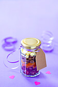 Screw-top jar with candied fruit and chocolate drops to give as a gift