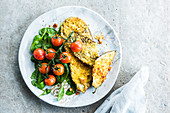 Breaded aubergine slices with spinach and cherry tomatoes
