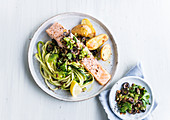 Salmon steak with courgette spaghetti, served with black olives and herbs
