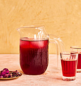 Red iced tea in a jug and glasses