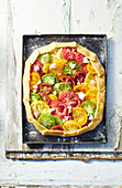 Unbaked tomato tart with colourful heirloom tomatoes