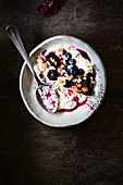 Muesli with yoghurt, almonds, blackberries and blueberries