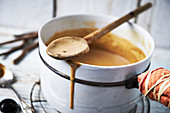 Melting liquorice in a pot for homemade liquorice ice cream