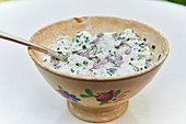 Bowl of cream cheese with herbs