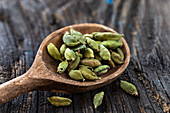 Cardamom seeds on a wooden spoon