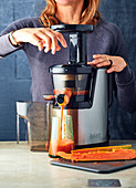 Woman using a juice extractor