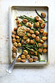 Grenaiiles potatoes roasted in the oven with green asparagus and hard-boiled eggs
