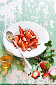 Strawberry fruit salad with almonds,honey and Timut pepper syrup