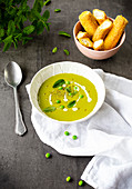 Cream of pea soup with fresh goat's cheese and beadsticks