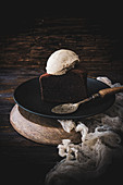 Portion of chocolate cake with a scoop of vanilla ice cream