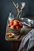Cup of ripe apricots on a kitchen table