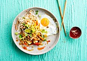 Vegetable noodles with fried egg and sesame seeds