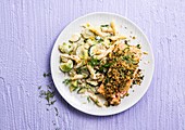 Salmon steak in herb crust and penne with leeks and zucchini