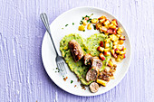 Sausage with mashed brussels sprouts and cooked apple cubes
