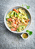 Bowl of quinoa with shrimps, pink grapefruit and avocado